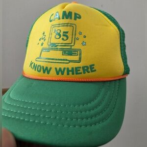 Stranger Things "Camp Know Where" Trucker Hat. Adjustable Snapback. Green/Yellow